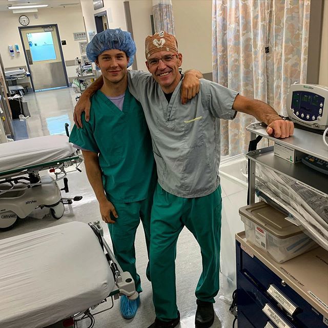 Research placement student, George, with his father Dr Andy Reed, in the operating room